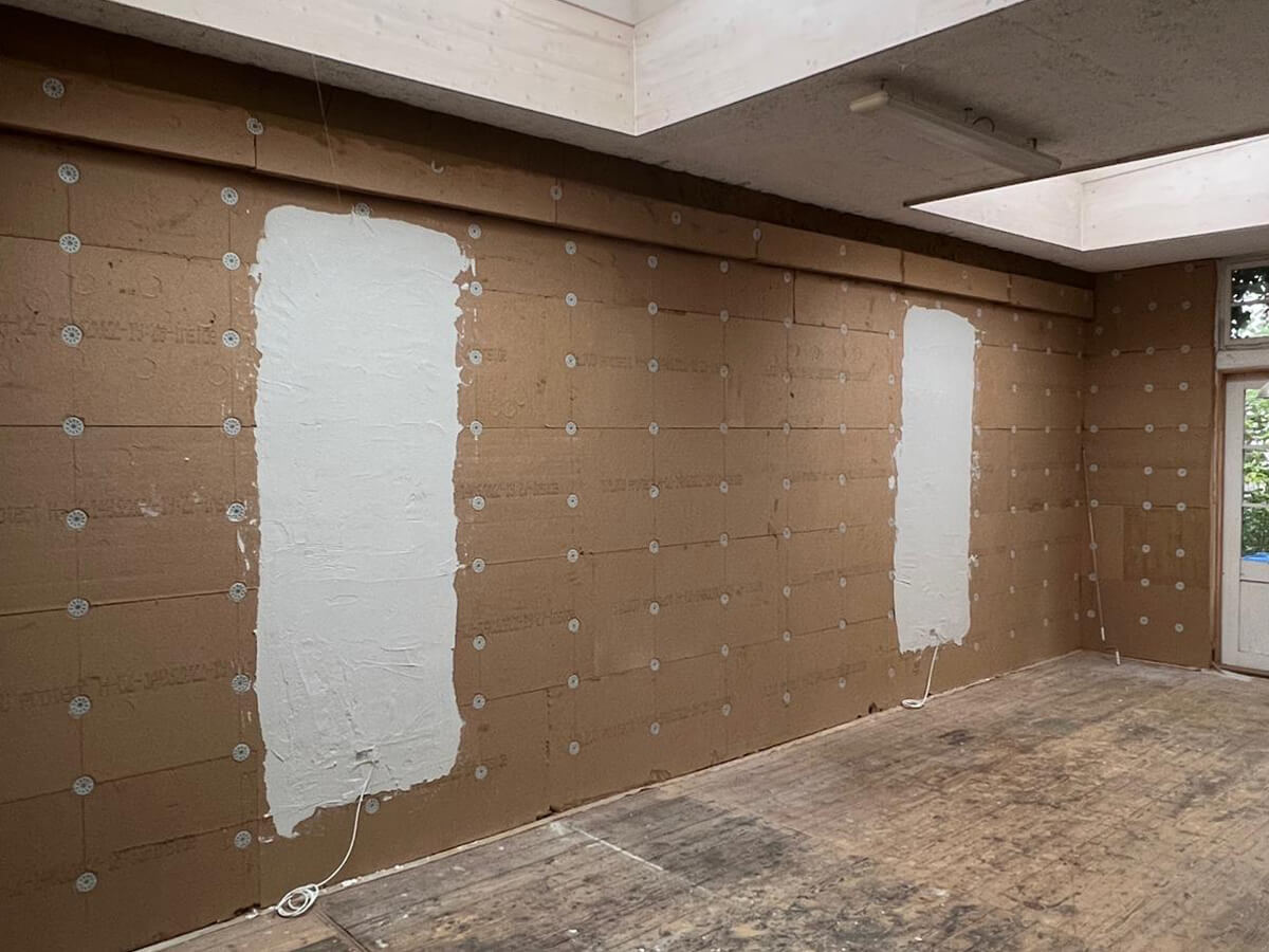 Unterputz-Heizelemente in einer Lehmputz-Wand, vor dem Verputzen